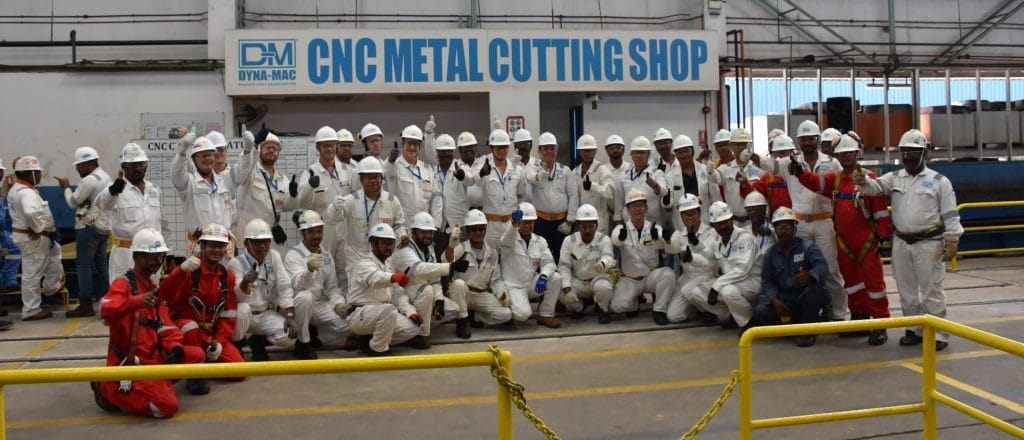 Personnel at strike steel ceremony for Liza Unity at Dyna-Mac